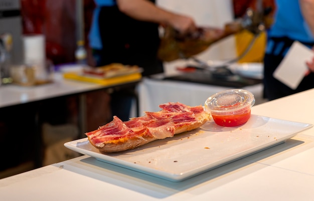 Spuntino tipico spagnolo della regione della Catalogna prosciutto serrano pane e pomodoro