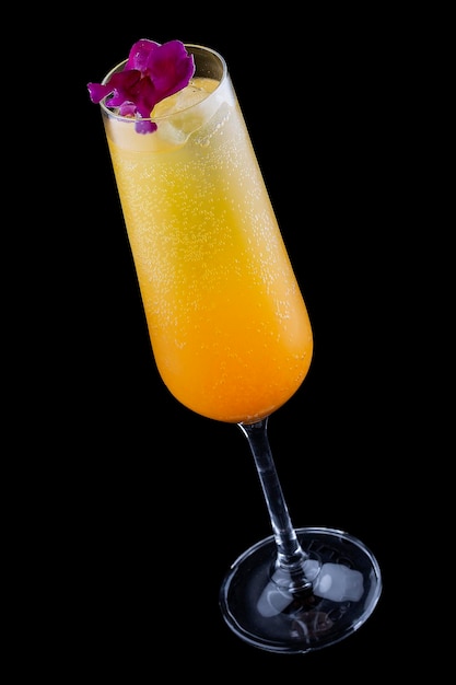 Squisito cocktail freddo con champagne e succo d'arancia su uno sfondo scuro
