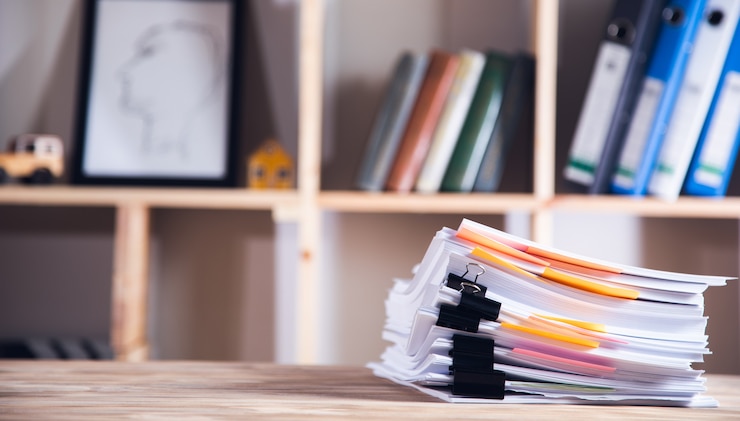 Photo stack of paper files on the table.