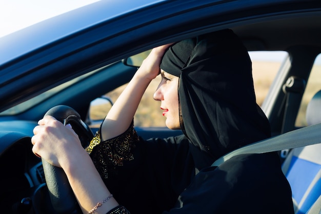 Stanco donna islamica nel traffico seduto al volante