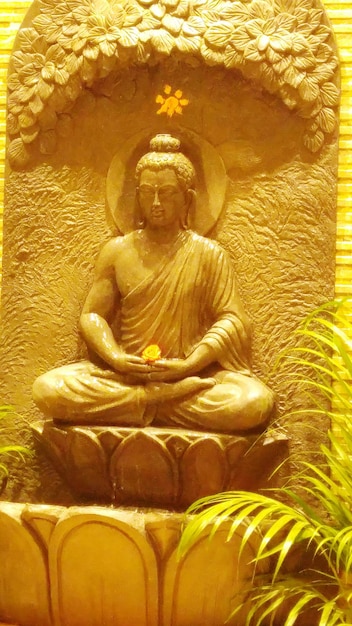 Statua di Buddha sul muro giallo