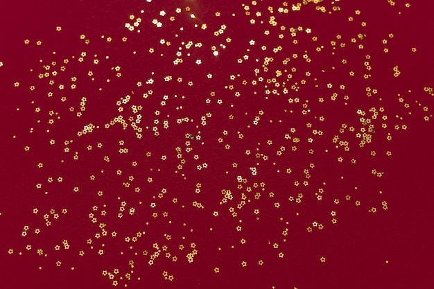 Stelle glitter oro su sfondo rosso scuro