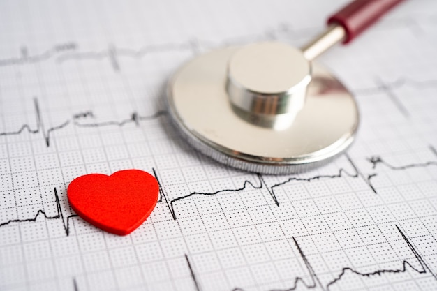 Stetoscopio sull'elettrocardiogramma (ECG) con cuore rosso, onda cardiaca, attacco di cuore, rapporto del cardiogramma.