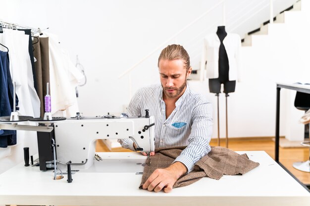 Stilista di abbigliamento che crea un nuovo design per un vestito - Stilista che lavora su un marchio di abbigliamento in una fabbrica tessile