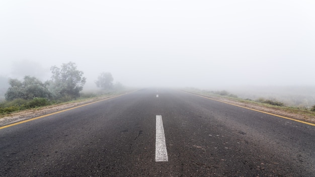 Strada autostradale vuota con tempo nebbioso