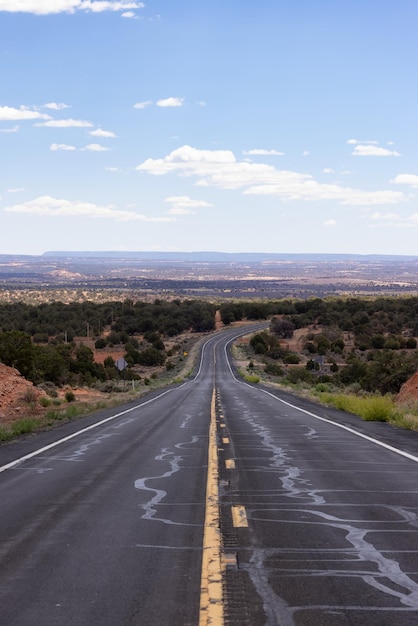 Strada panoramica nel deserto secco con montagne rocciose rosse sullo sfondo