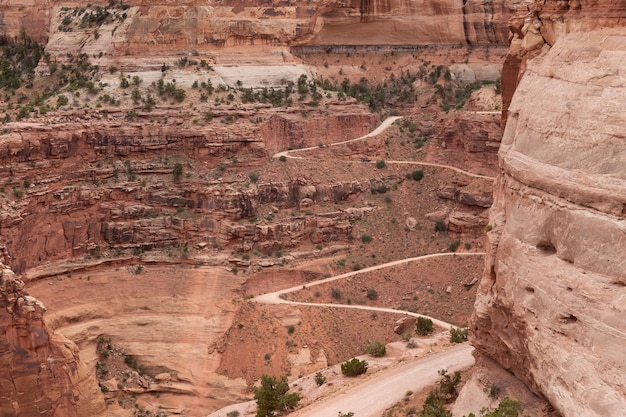 Strada sterrata panoramica circondata da montagne di roccia rossa nel canyon del deserto