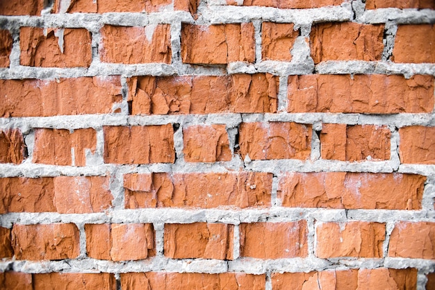 Struttura del muro di mattoni. Close-up vecchio muro di mattoni rossi rotti, sfondo. Muratura