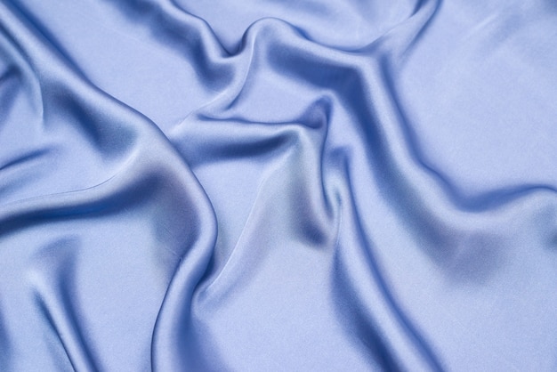 Struttura del tessuto di lusso in seta o raso blu. Vista dall'alto.