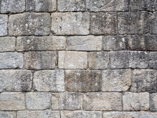 Struttura della parete con muratura in pietra di colore grigio Architettura della struttura del fondo di concetto