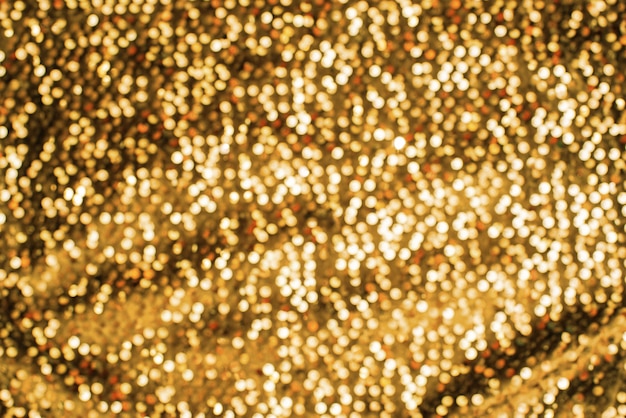 Struttura festiva luccicante del fondo di defocus lucido di colore dell&#39;oro