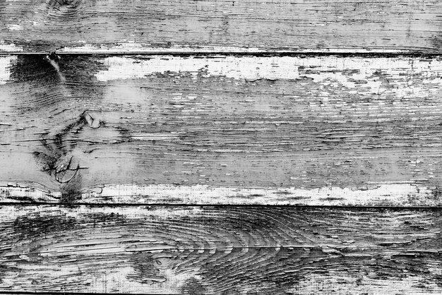 Struttura in legno di colore grigio con graffi e crepe, che può essere utilizzata come sfondo