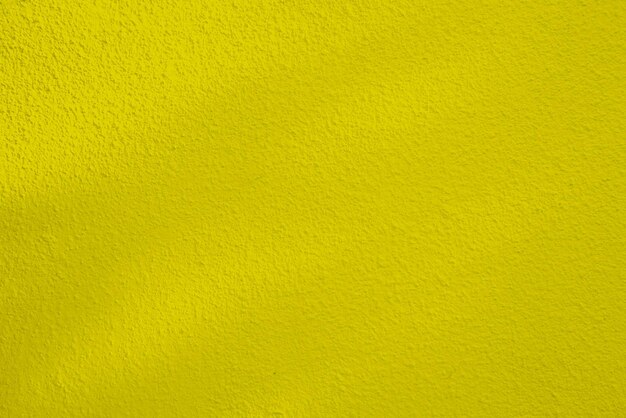 Struttura senza cuciture del muro di cemento giallo una superficie ruvida con spazio per testo per un backgroundx9