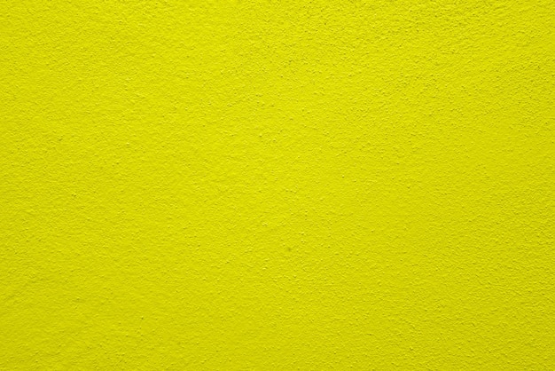 Struttura senza cuciture del muro di cemento giallo una superficie ruvida con spazio per testo per un backgroundx9