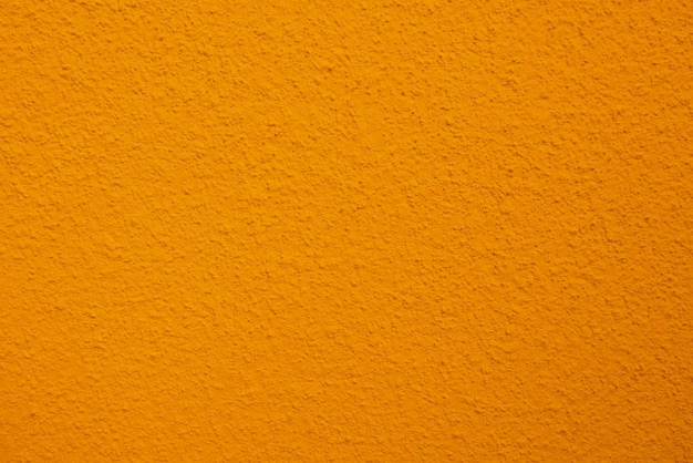 Struttura senza cuciture del vecchio muro di cemento giallo una superficie ruvida con spazio per testo per un backgroundx9