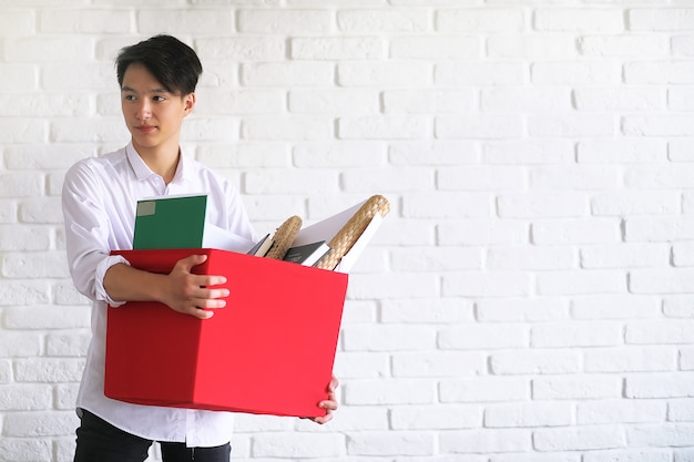 Studente asiatico del giovane con i libri in mani