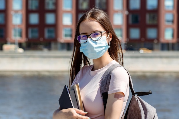 Studentessa adolescente in maschera medica protettiva con cerotto a portata di mano torna a scuola dopo le vacanze estive gli adolescenti ricevono il vaccino contro il covid19