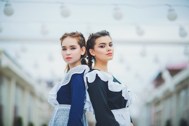 Studentessa in piedi con tipico grembiule uniforme bianco navy