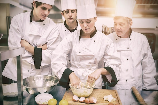 Studenti culinari che imparano a mescolare la pasta in cucina