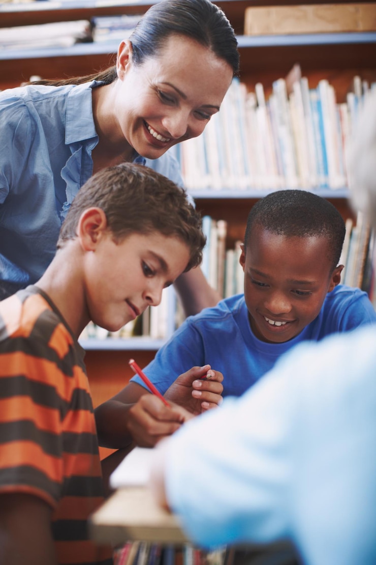 Photo students teacher and learning in library for teaching education and study with support and guide children woman and development in school for help diversity and academic challenge with kindness