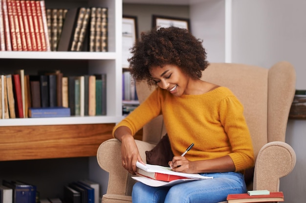 Studi quotidiani Foto ritagliata di una giovane donna attraente che studia sul suo divano