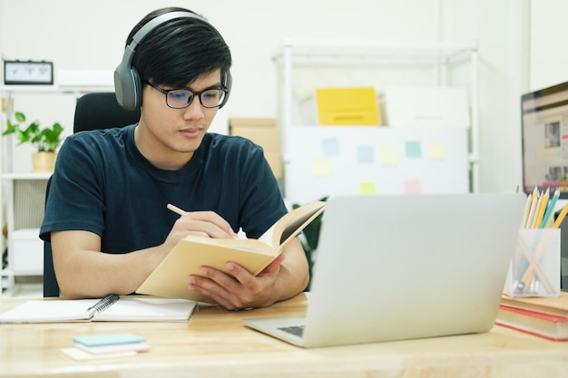 Studio del giovane davanti al computer portatile a casa