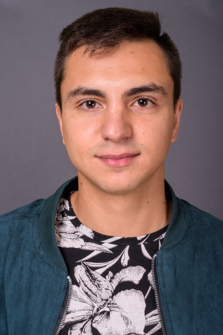 Photo studio shot of young handsome man against gray background