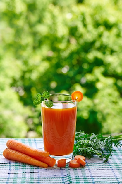 Succo di carota fresca in un bicchiere sul tavolo