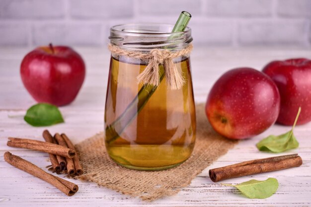 Succo di mela con cannella in un barattolo. Avvicinamento.