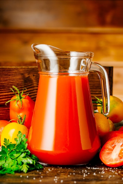 Succo di pomodoro fresco in un bicchiere con pomodori Bevanda vegetale al pomodoro per un'alimentazione sana