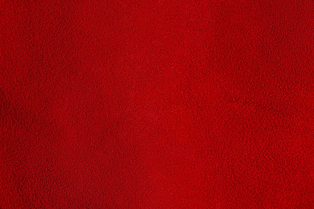 Suede rosso come materiale di sfondo per i designer sfondo di velluto rosso