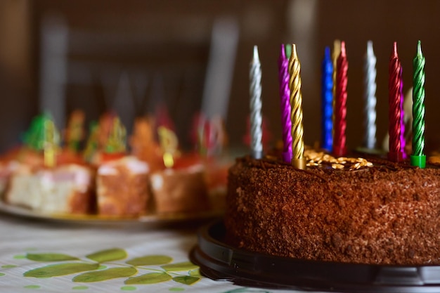 Sul tavolo c'è una torta di compleanno al cioccolato con candele