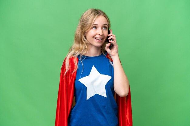 Super Hero donna inglese su sfondo isolato mantenendo una conversazione con il telefono cellulare