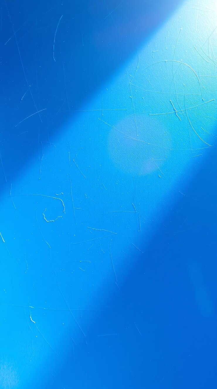 Superficie blu della carta da parati con un raggio di luce diagonale che proietta un'ombra su di essa