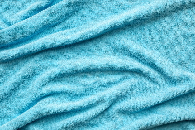 Superficie di struttura del tessuto asciugamano blu vicino sfondo