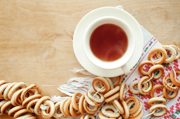Sushki e tazza di tè su sfondo di legno Vista superiore piatta delle tradizioni nazionali russe