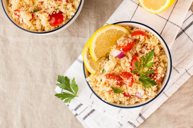 Tabouleh è un'insalata vegetariana araba a base di cuscus, pomodori, prezzemolo, cipolla e succo di limone