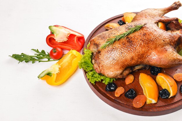 Tacchino al forno con verdure e spezie Giorno del Ringraziamento Griglia di pollo d'oca su sfondo di legno Vista dall'alto