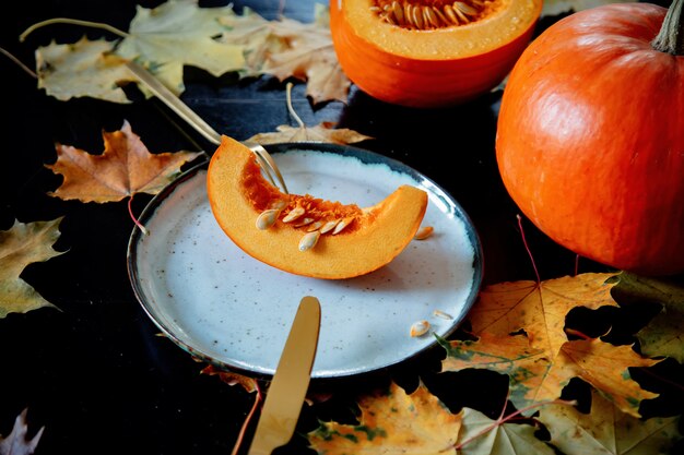 Tagliare la zucca su un piatto con posate sul tavolo