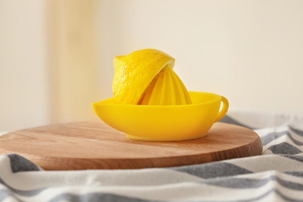 Tagliere con spremiagrumi e limone fresco sul tavolo