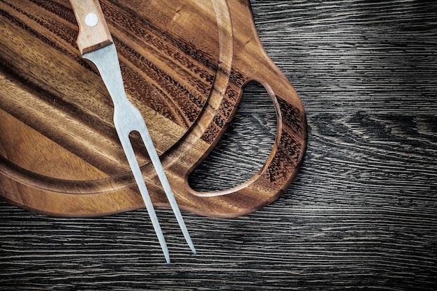 Tagliere della forcella della carne su fondo di legno