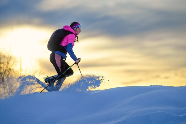 Tanta neve fresca che si sposta dove passa una ragazza con le ciaspole