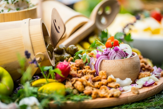 Tavola del buffet di catering con un cibo delizioso - decorazione di erbe di verdure con salsiccia di pancetta.