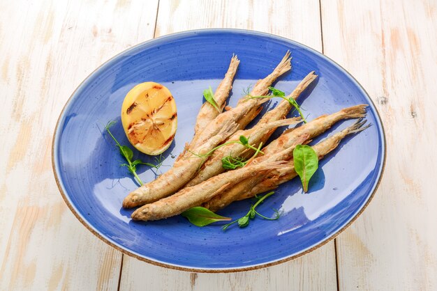 Tavola di legno con odore di pesce fritto e insalata