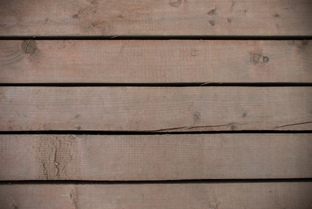 Tavole di legno marrone con fori tra loro texture. spazio per il design