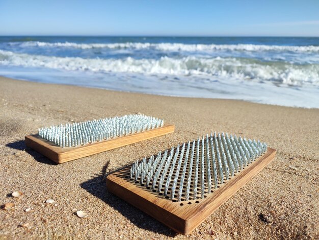 Tavole SADHU sul primo piano della spiaggia del mare Strumento yoga per il relax, la consapevolezza e la riduzione dello stress