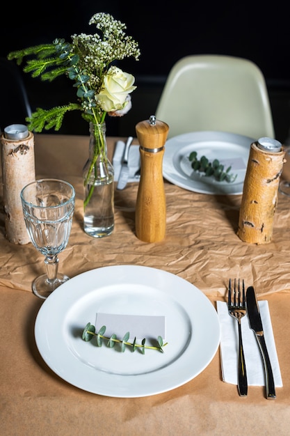 Tavolo decorato pronto per la cena. Tavolo splendidamente decorato con fiori, candele, piatti e tovaglioli per il matrimonio o un altro evento nel ristorante.