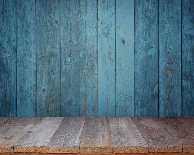 Tavolo in legno bianco su uno sfondo di parete blu.