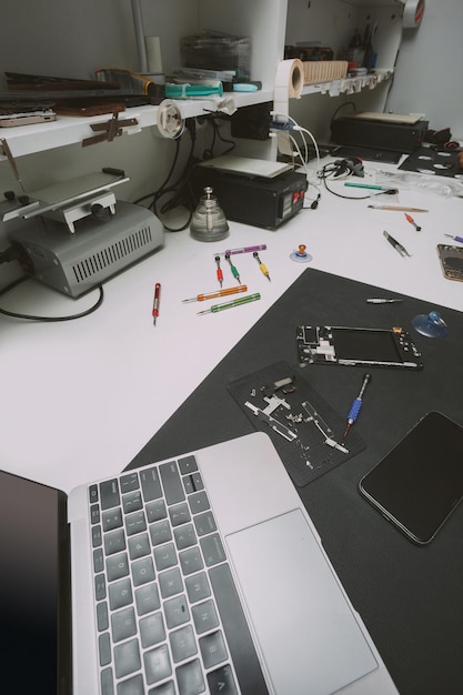 Tavolo officina riparazione cellulari con pezzi di ricambio