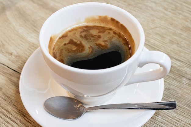 Tazza di caffè bianco sul tavolo di legno